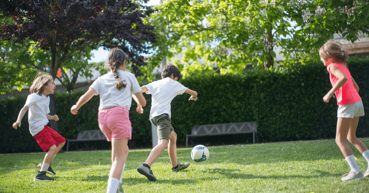 Kids playing a game soccer at a play park in Cape Town
