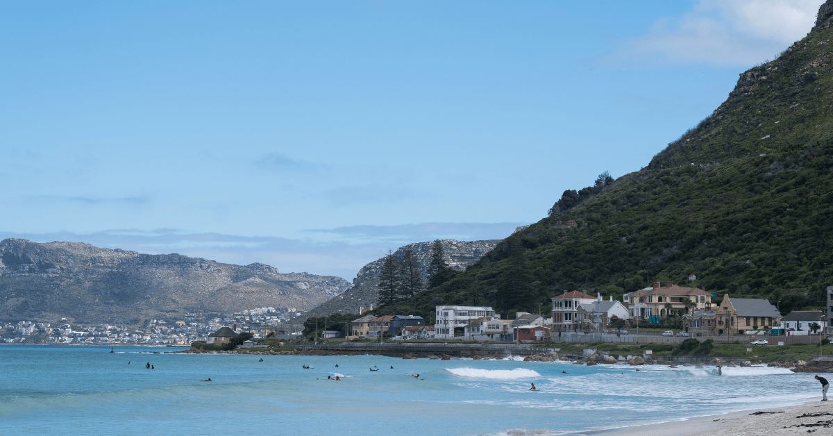 Many surfers practising in the blue water of Muizenberg Beach 