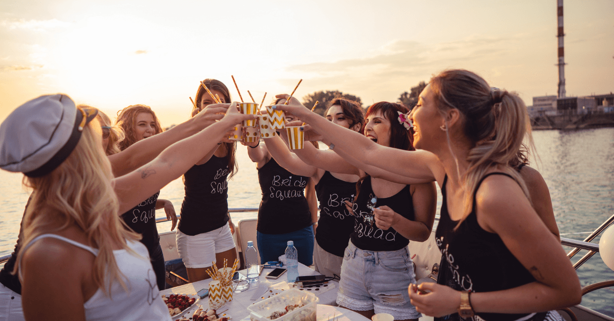 Group of women celebrating a beachside bachelorette party on a catamaran 