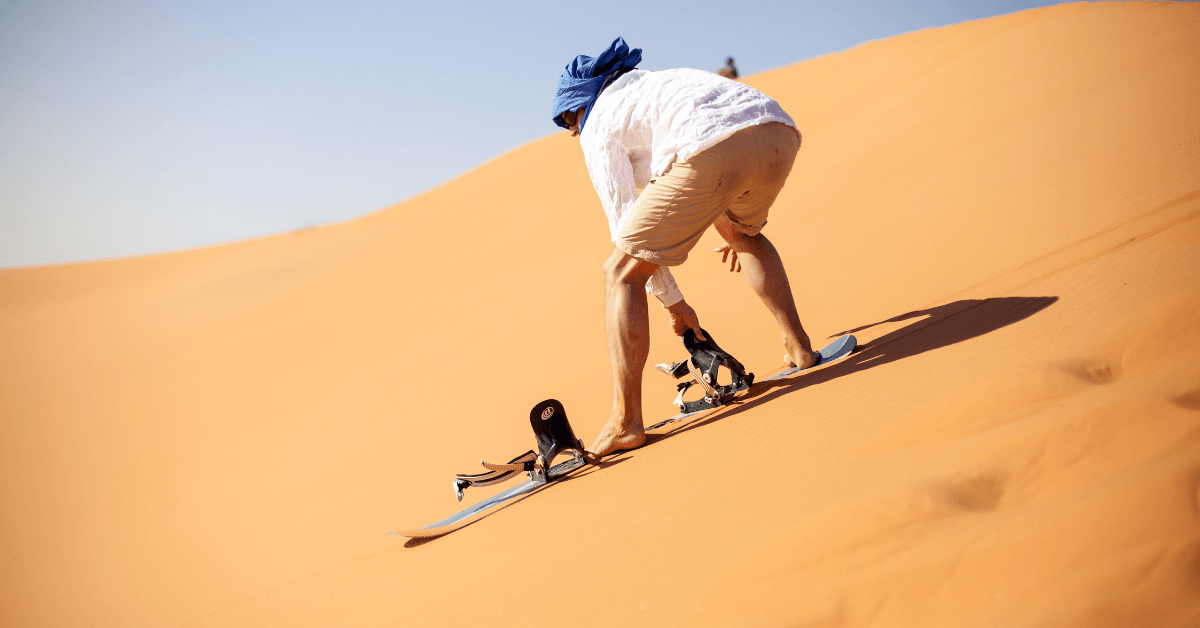 A person sandboarding the Atlantis Dunes in Cape Town