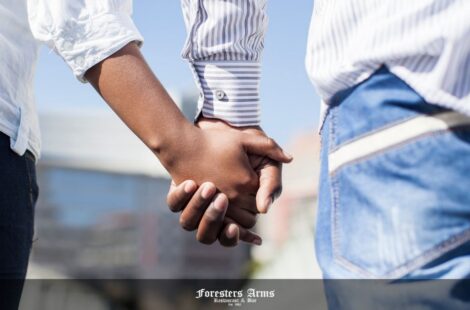 places to visit in cape town for couples feature image - lady looking at a sunset and devils peak with her hand holding her partners
