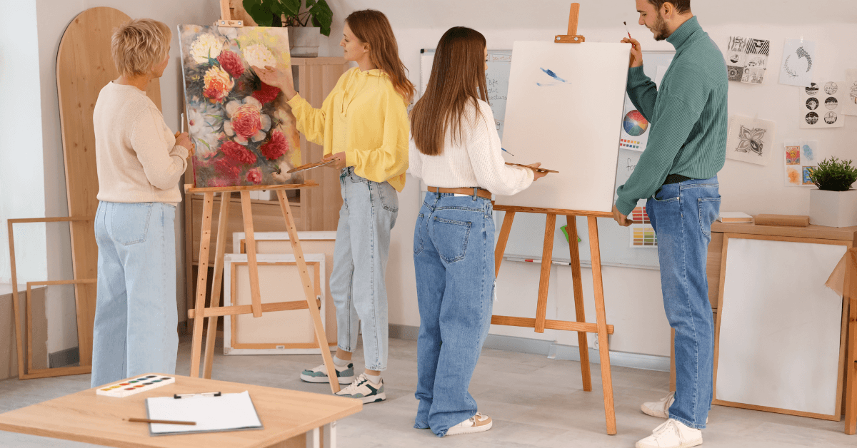 Group of colleagues painting together at art jamming workshop 