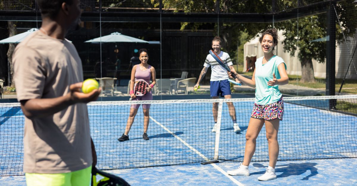 Group of colleagues enjoying a padel match 