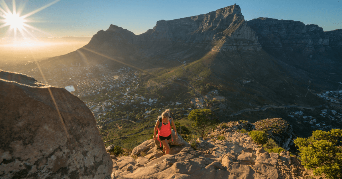 Person hiking Lions head with views of Table Mountain 